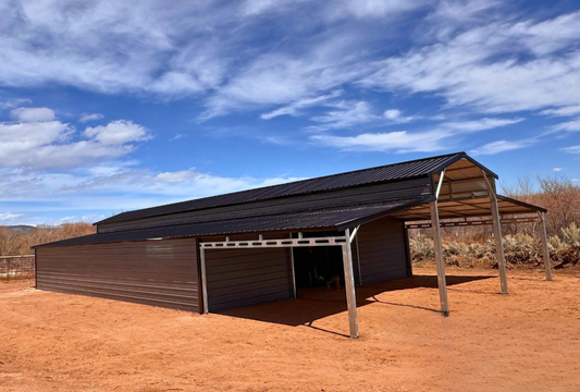 36'x80'x12' down to 10'-8' steel barn with lean-tos, two panels under the eave, both sides closed @ 60'L, all ends closed & front porch, front left view.
