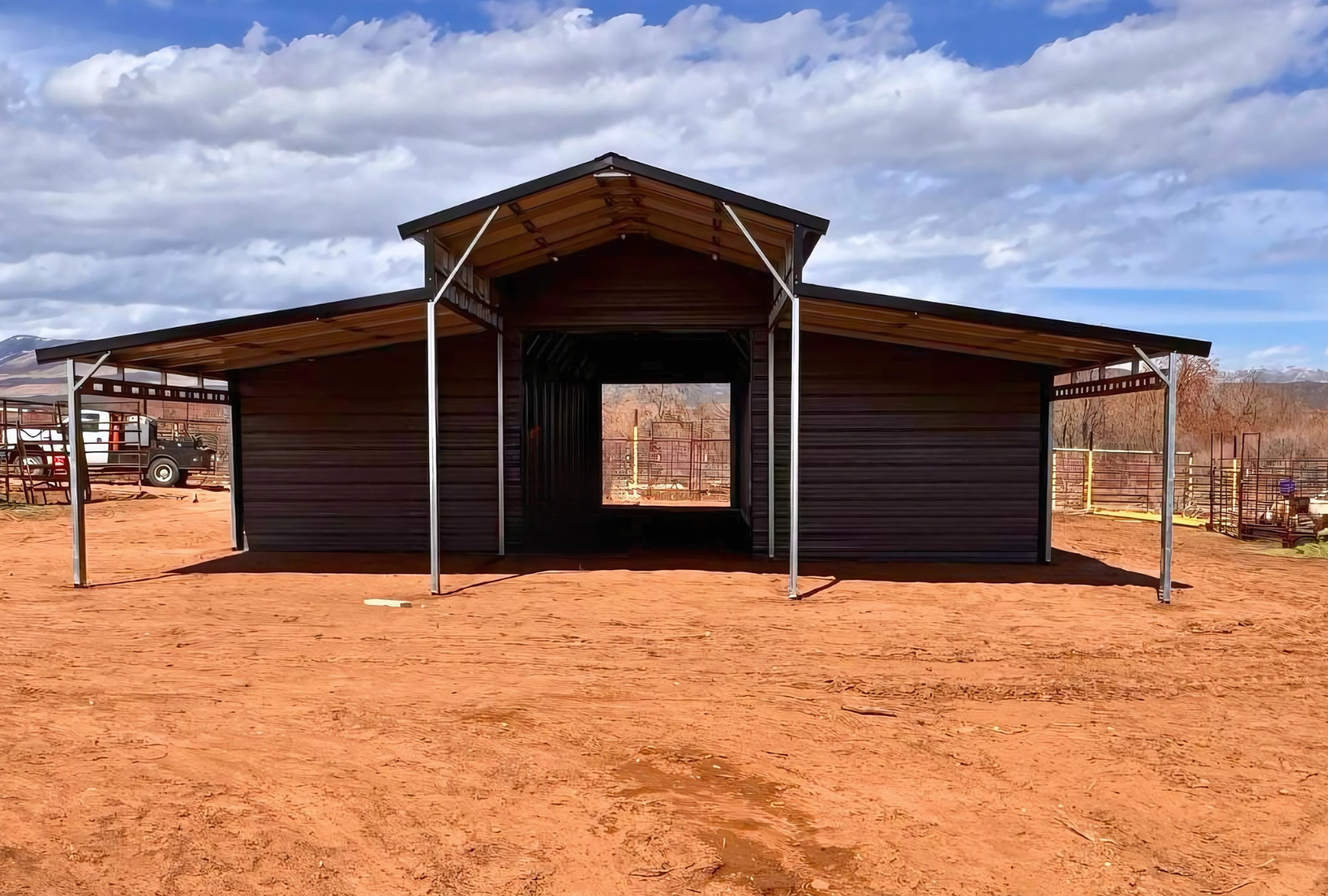 36'x80'x12' down to 10'-8' steel barn with lean-tos, two panels under the eave, both sides closed @ 60'L, all ends closed & front porch, front view.