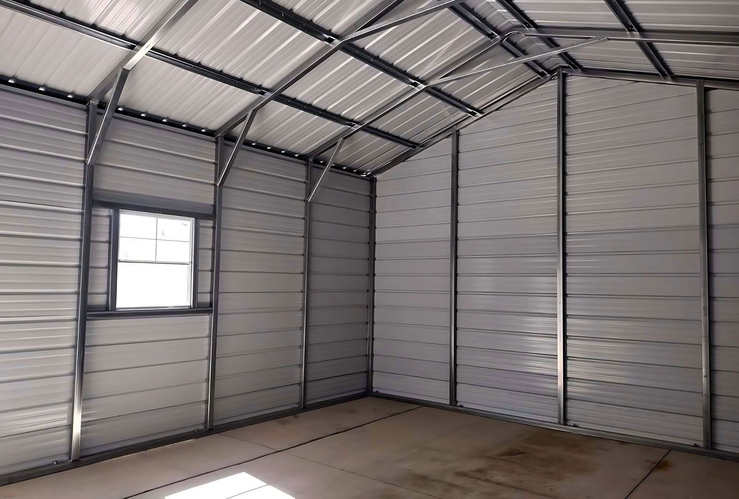 Inside left view 18'x25'x10' f-frame vertical roof building with roll-up door, walk-in door, and window.