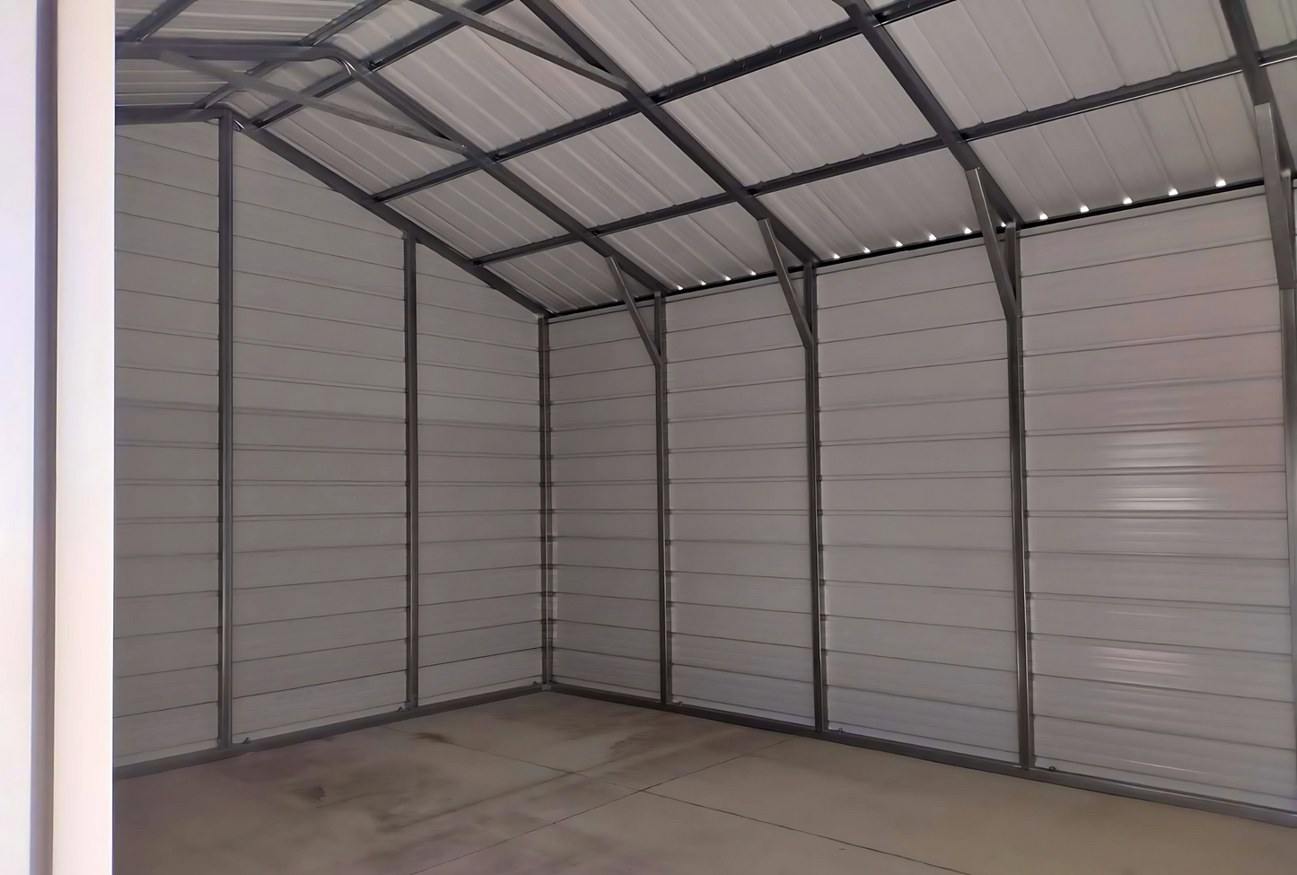 Inside right view 18'x25'x10' f-frame vertical roof building with roll-up door, walk-in door, and window.