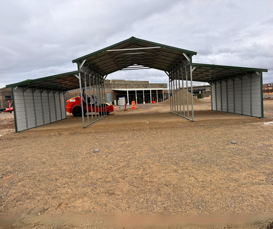 44'x25'x12' down to 10'-8' steel barn with lean-tos, two panels under the eave and closed on both sides.