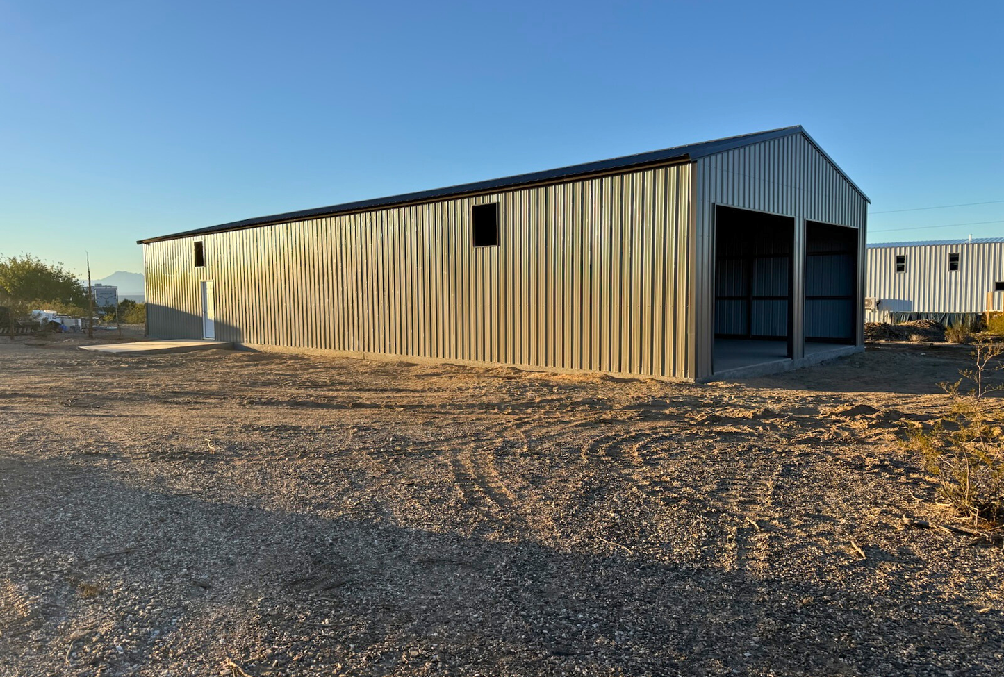 Angled left exterior of a 30x80 prefab A-frame steel building by Alpha Steel Buildings with vertical roof and enclosed sides — perfect for garages, storage, or commercial use.